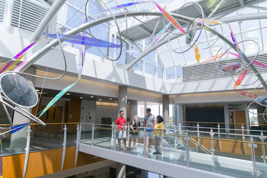 Students talk on a walkway in the Bond Life Sciences Center